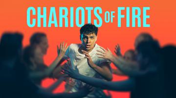 Promotional image for Chariots of Fire. Against a bright orange background, a young man runs with determination through a wave of blurred arms. Text reads: CHARIOTS OF FIRE