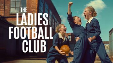 In the courtyard of a factory, three people wearing blue boilersuits scream with joy and triumph. One holds a brown leather ball, one punches the air and one grabs the other's waist. Text reads: THE LADIES FOOTBALL CLUB