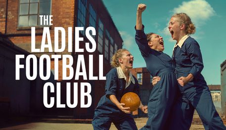 Four people wearing blue boilersuits scream with joy and triumph. Text reads: THE LADIES FOOTBALL CLUB