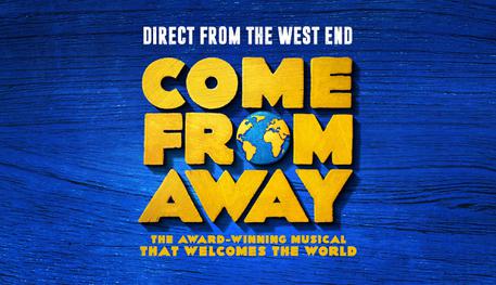 Promotional artwork for Come From Away with the show title written in thick yellow capital letters with a globe used in place of the "o" in "from". Text reads "The award-winning musical that welcomes the world" in yellow font on a textured blue background.