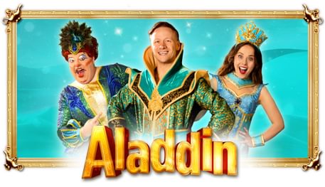 Three people wearing blue, green and gold pantomime clothes smile above the title ALADDIN