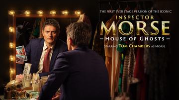 Promotional image for Inspector Morse featuring Tom Chambers as Morse looking into a mirror with lights around it in the dressing room of a theatre. He wears a navy suit, with white shirt and red tie.