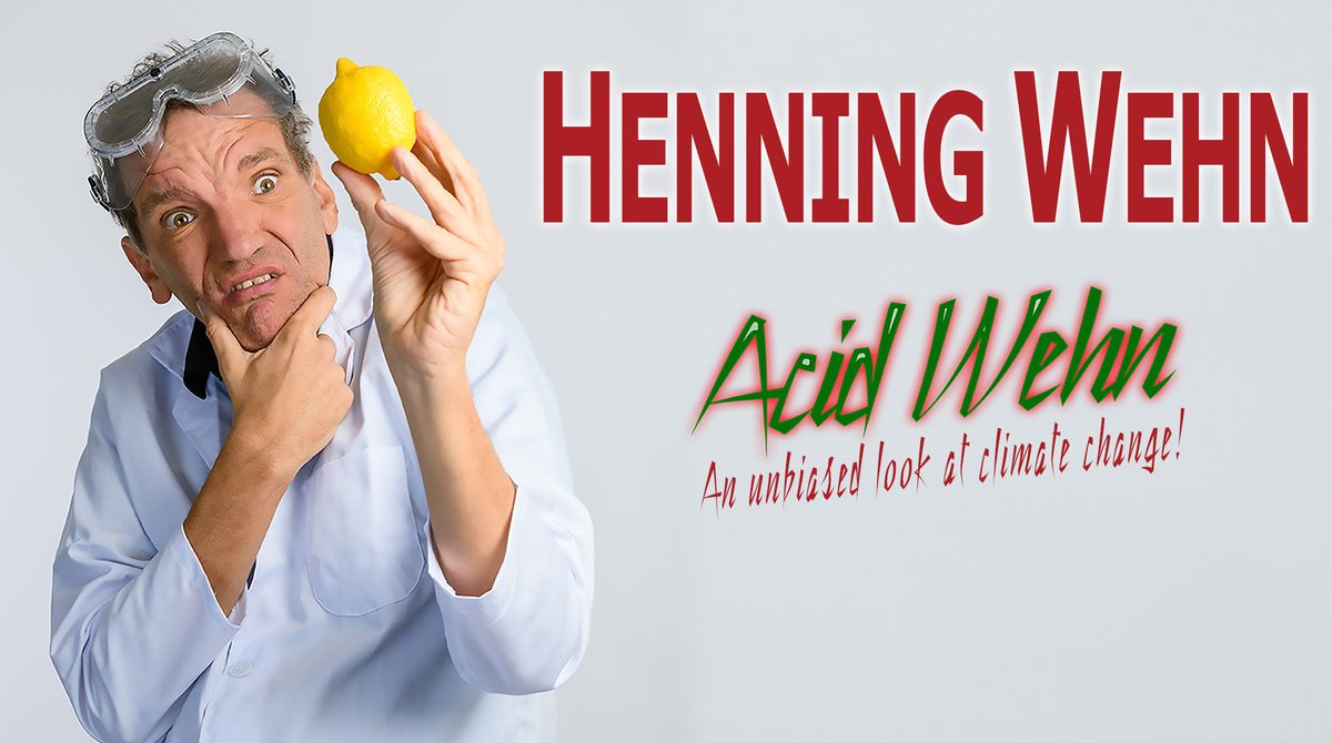 Promotional artwork featuring Henning Wehn wearing a white shirt and science goggles on his head. He holds a lemon and looks confused. Text reads "An unbiased look at climate change!"