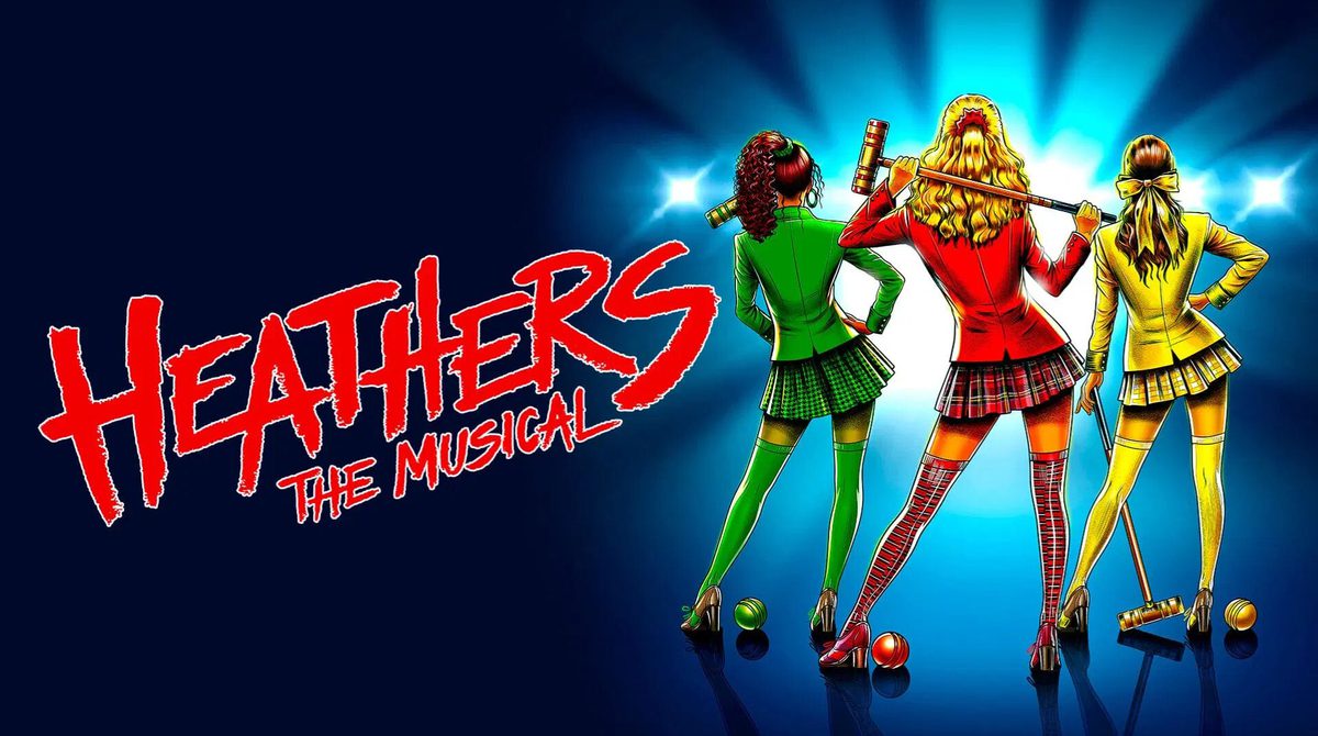 Promotional image for Heathers featuring an illustration of three girls, all facing away from the camera. On the left there is a girl holding a green croquet mallet. She is wearing a green fitted blazer and a short skirt. She has black mid length hair. In the middle there is a girl wearing a red fitted blazer and a red chequered short skirt. She has long wavy blonde hair. She is holding a red croquet mallet. On the right there is another blonde woman. She is wearing a yellow fitted blazer and yellow and white striped short skirt.. She has shoulder length wavy hair. She is also holding a yellow croquet mallet. There is a croquet ball by each of their feet.