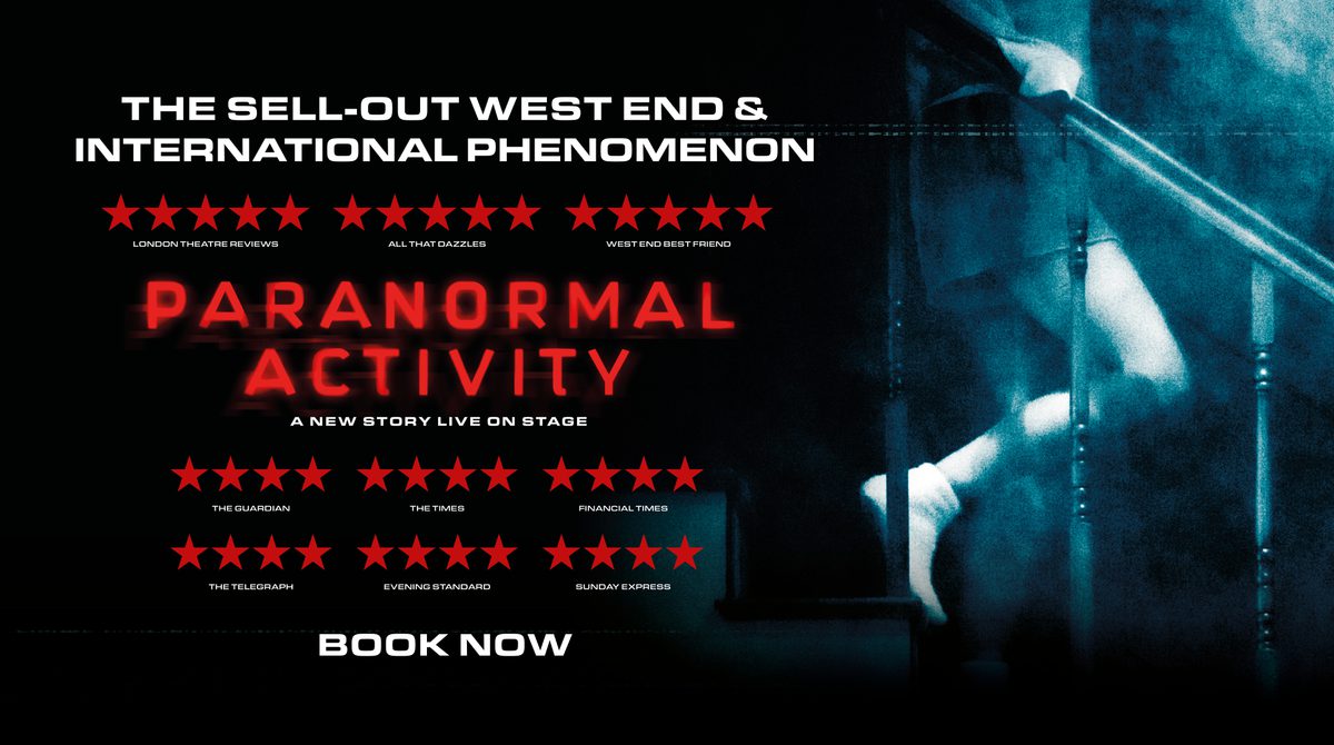 Promotional image for Paranormal Activity featuring a darkly lit room illuminated by a ghostly light as a person descends a staircase. Only their legs and torso are visible.