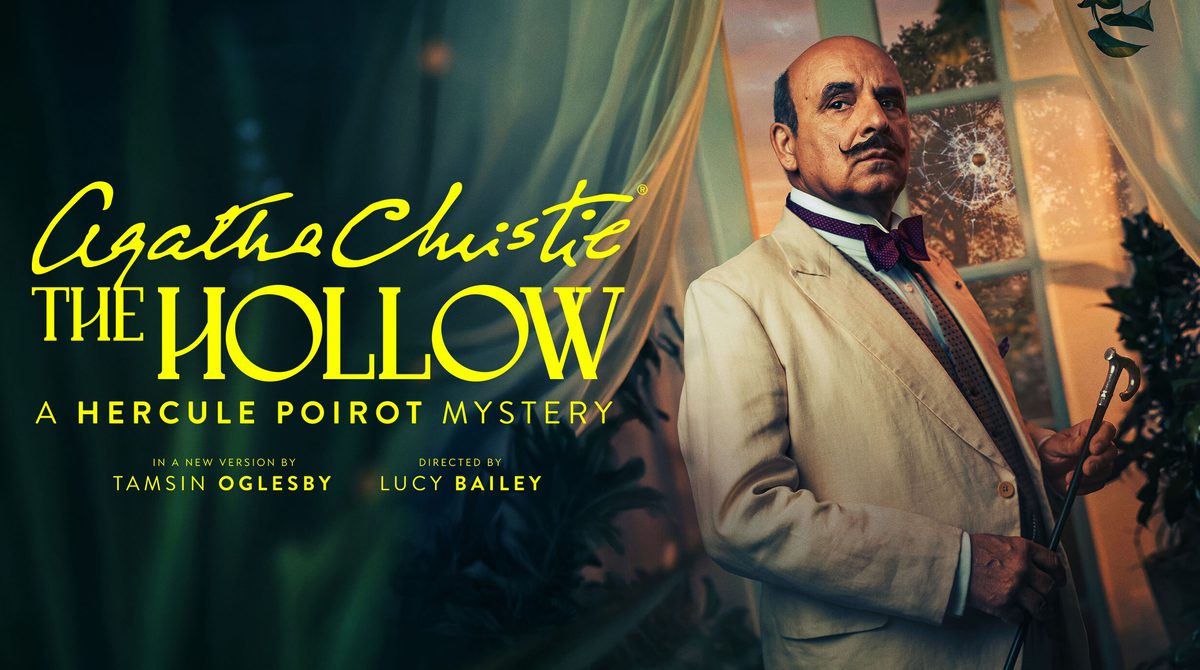 Promotional image for Agatha Christie's The Hollow. Featuring Peter Polycarpou as Hercule Poirot, a balding man with dark hair and moustache wears a creme suit with bow tie. He holds a walking cane in front of a window with a bullet hole breaking the glass.
