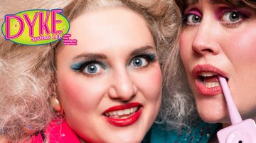 2 white women looking directly into the camera set against a blue background. The woman on the left has large blonde hair and is wearing a pink suit holding a wad of American dollars, with bright blue eyeshadow and red lipstick. The woman on the right has a brown pixie cut, wearing bright pink shadow, holding a 80s coded pink phone to her mouth.
