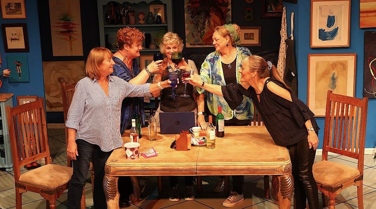 Production image for Invisible featuring a group of middle aged women standing round a dining table making a toast with glasses of wine.
