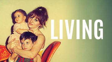An old photograph of a young mother smiling, holding a toddler in one arm and hugging their other around a young child. They sit on an orange chair at a table. Text reads LIVING