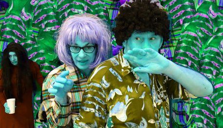 Promotional image for Cold Sweat featuring a man and woman with turquoise skin and contrasting hair colours. They wear colourful patterned shirts. Behind them, a woman with long black hair holds a cup. They stand against a green leafy background.