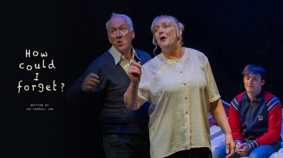 Production image for How Could I Forget featuring a man and woman, both with grey hair, talking animatedly. A younger man wearing a tracksuit jacket sits on a bed behind them.