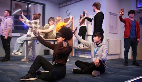 Students perform on stage in the schools response project to Sheffield Theatres Production of Accidental Death of an Anarchist.