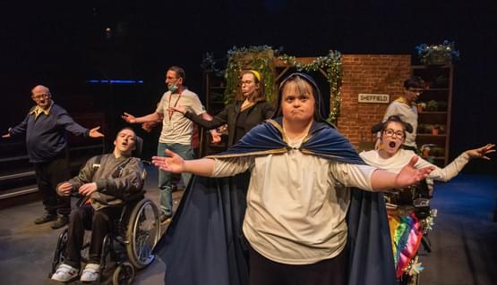 The cast of Garden of Hope perform. 6 cast members open their arms to the audience