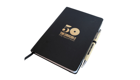 Black notebook with gold foil 50 logo and bamboo ballpoint pen
