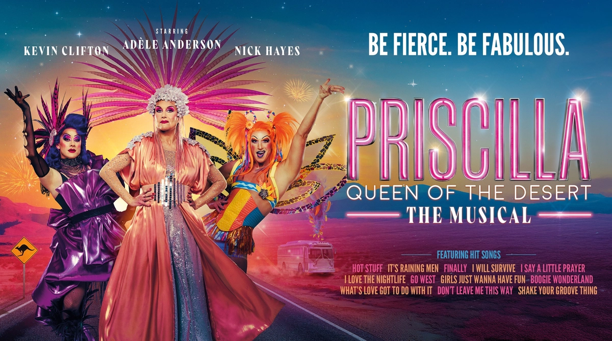 Promotional image for Priscilla featuring Kevin Clifton, Adèle Anderson and Nick Hayes in colourful drag costumes standing on an Australian highway road. Text ready Be Fierce. Be Fabulous.