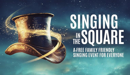 A top hat swirls with magical golden sparkles against a blue night sky. Text reads: SINGING IN THE SQUARE