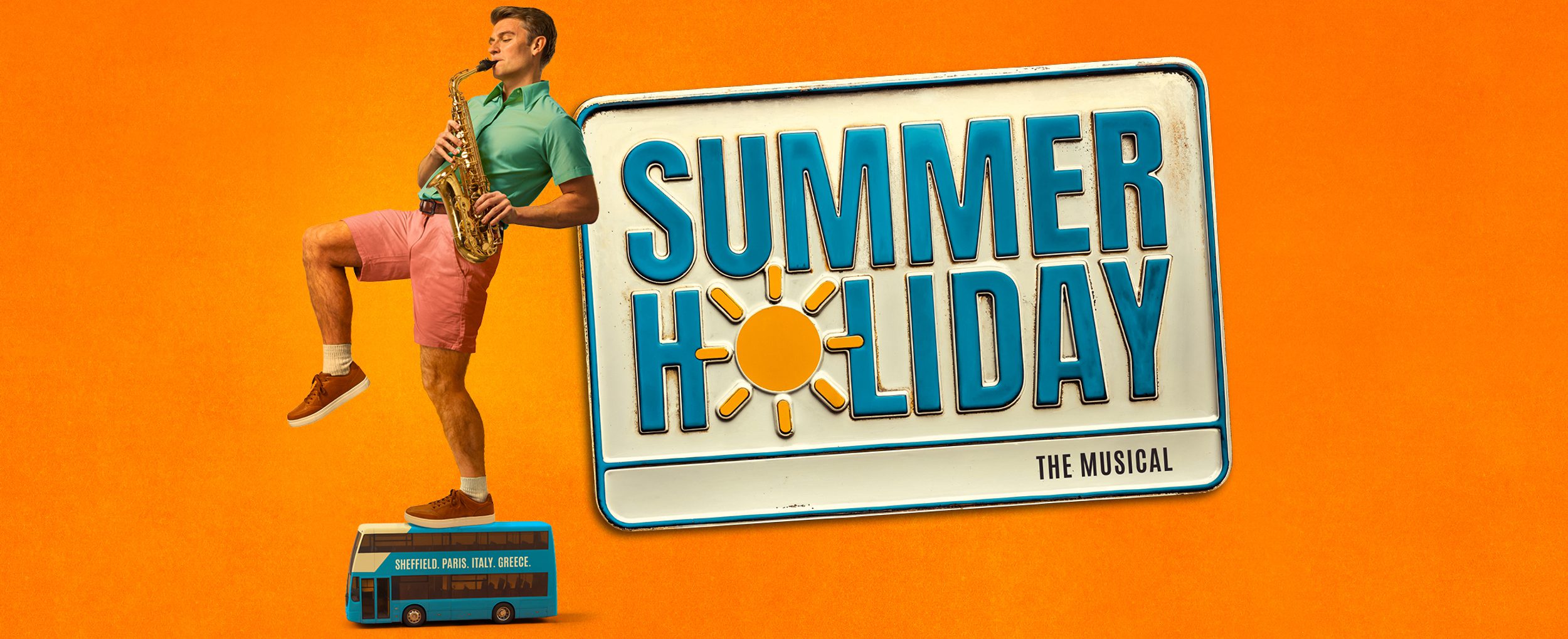 Against a warm orange background, a person wearing pastel-coloured shorts and a t-shirt plays a saxophone. They balance on one leg, standing on a miniature double decker bus. A blue and white stamped sign reads SUMMER HOLIDAY