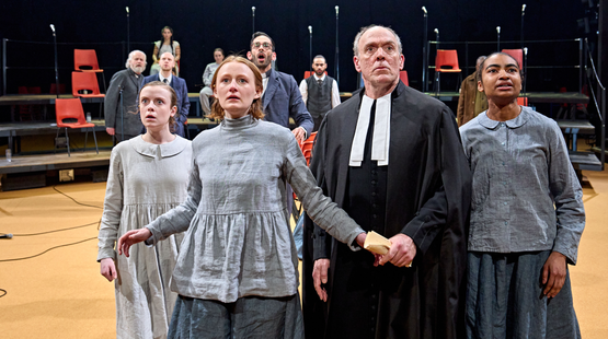 Honor Kneafsey (Betty Parris), Rose Shalloo (Abigail Williams), Ian Drysdale (Deputy Governor Danforth), Jasmine Elcock (Mercy Lewis) and the Company in The Crucible. Photo by Manuel Harlan.