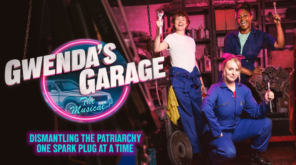 Gwenda's Garage | Three woman in blue overall's are in a car garage smiling and holding tools.