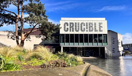 The Crucible Theatre in the sunshine with blue sky behind