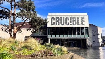 The Crucible Theatre in the sunshine with blue sky behind