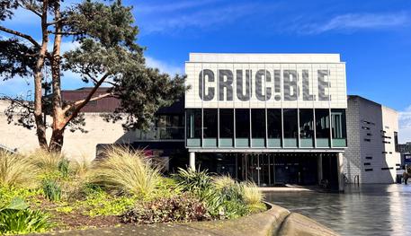 The Crucible Theatre in the sunshine with blue sky behind